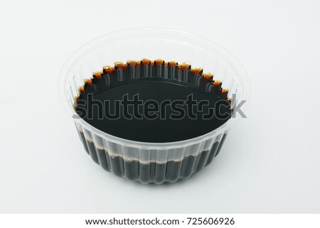 soy sauce in a disposable crockery on a white background