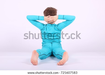 boy doing an exercise out of yoga bending in the back