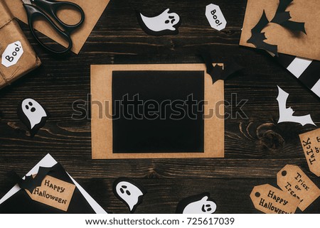 Halloween card with halloween decoration made of craft paper. Copy space