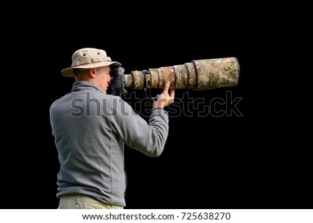 Professional wildlife photographer isolated on black background