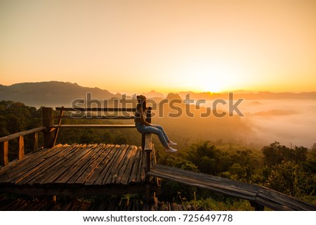 Happy woman on viewpoint  at the morning.Enjoying with nature