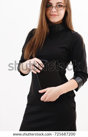 girl with a notepad and pen in her hands, student, schoolgirl or business lady on a photo shoot