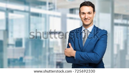 Young manager smiling in a modern office Royalty-Free Stock Photo #725692330