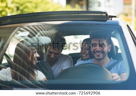 Group of happy friends on a car Royalty-Free Stock Photo #725692906