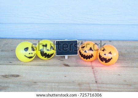 Self Made Hand Drawn Smiley Halloween face on yellow and a blank black signboard