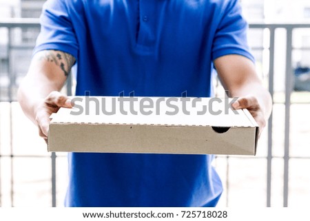 Delivery man holding boxes with pizza