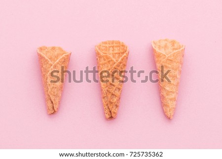 empty wafer cone on pink background