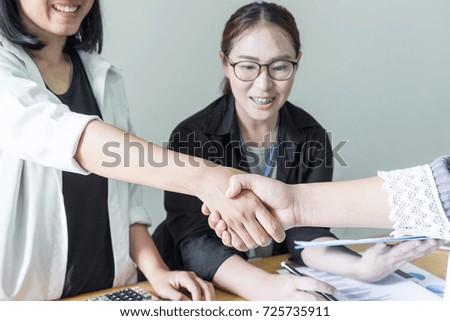 Business partner greeting each other with handshake
