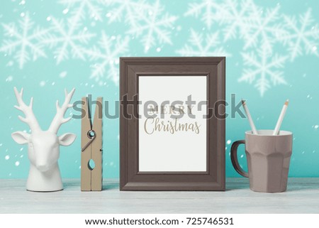 Christmas holiday frame mock up with deer decoration on wooden table. Nursery or kids room interior background