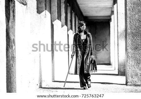 Fashion art portrait of elegant girl in geometric. Black and white photo of stylish young woman in cityscape