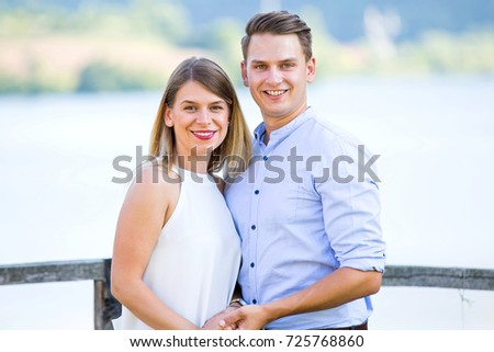 Picture of a beautiful couple in love posing outdoor on summertime