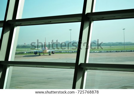 picture of airport window airplane on runway