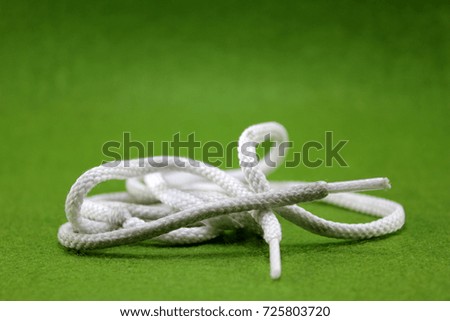 String knotted on a green background