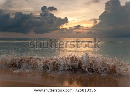 Stormy ocean on sunset background. Tropical beach