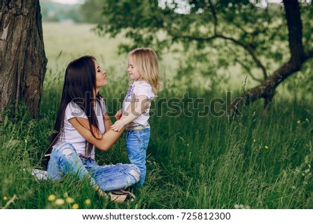 child near tree with mom