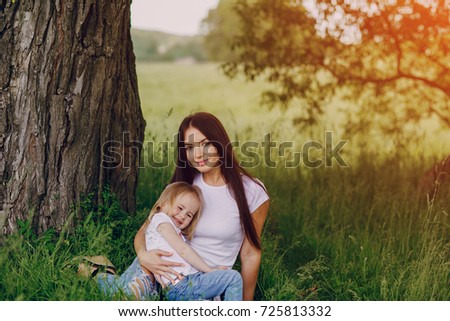 child near tree with mom