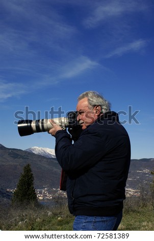 Nature photographer with digital camera on top of the mountain, Epirus, norhern Greece. (near Vikos canyon)