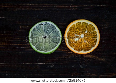 Close focus of hand holding sweet oranges and lemon cut off with copy space for text or advertising