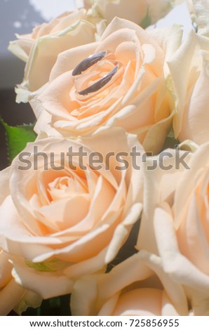 yellow roses and wedding rings