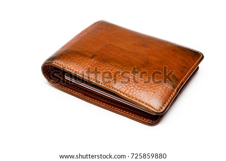 Used brown leather wallet or purse on isolated white background.