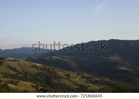 A beautiful landscape of various mountains is shot in the daytime from a bird's eye view