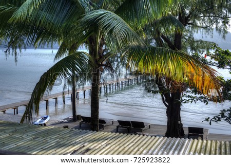 view top on sea Koh Kood through palm trees
