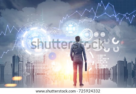 Rear view of an unrecognizable young businessman looking at graphs and HUD in a cloudy city. Toned image double exposure mock up Elements of this image furnished by NASA