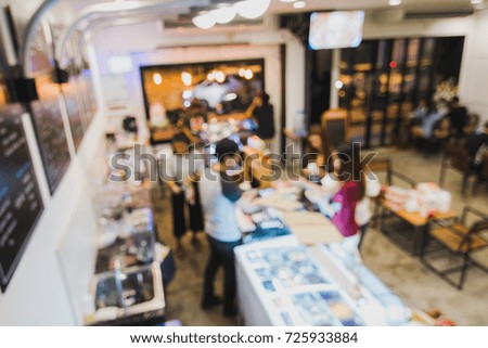 defocused a women pay a money with cashier in coffee shop