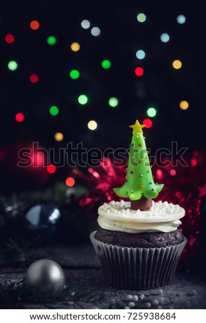 Christmas tree cupcake on wooden background,selective focus 