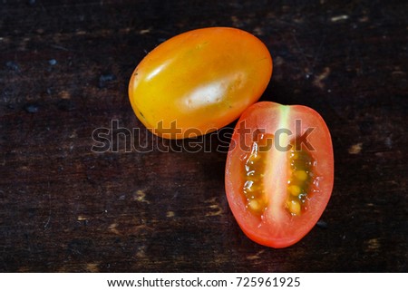 Red tomato on baclk background with shadow