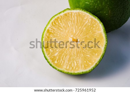 Green lemon on black background 
