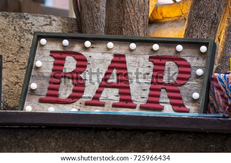 Vintage decorations: a neon sign of a bar with a frame of bulbs
