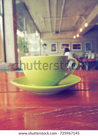 Coffee cup on table in coffee shop.