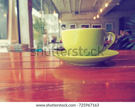 Coffee cup on table in coffee shop.