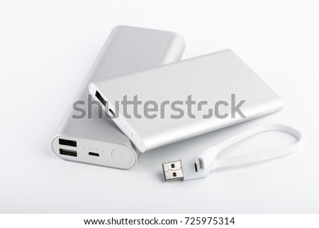 Power bank for charging mobile devices. White smart phone charger with power bank (battery bank). External battery for mobile devices. Royalty-Free Stock Photo #725975314