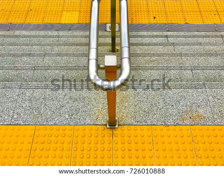 The facility for disable people and handrail for who walk up or down the step with yellow sign