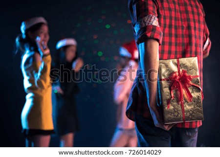 Gift in the behind of man who will surprise woman in dancing pub or bar, Couple and Lovers concept