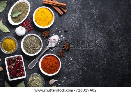 Set of Various spices on black stone table. Top view with copy space.