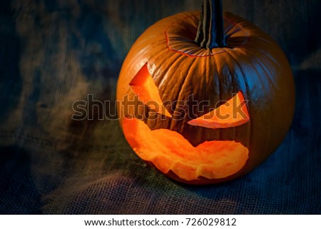 Halloween pumpkin head with burning candles