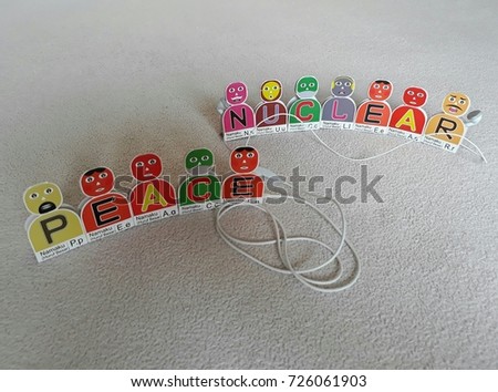 Alphabetical Cartoon Each Named Letters: P,E,A,C,E,N,U,C,L,E,A,R standing near earphone cable.