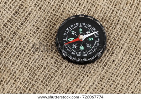 Compass on a used sack as a background