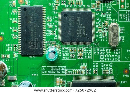 Close up top view image of green microchip. Green microchip as a motherboard for computer laptop and wireless router. green microchip background with resistors and capacitor. 