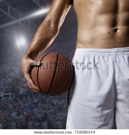 Basketball player hold a ball on professional arena. Player wears unbranded clothes. Stadium made in 3D.