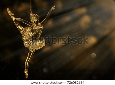 Glass ballet dancer on Dark background. Old style. Selective focus