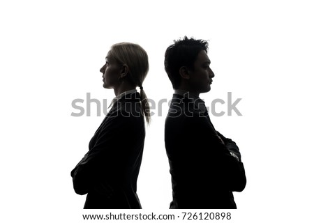 Silhouettes of caucasian businesswoman and asian businessman standing back to back. Royalty-Free Stock Photo #726120898