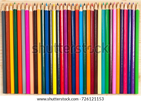Bright colour pencils for drawing over wooden surface