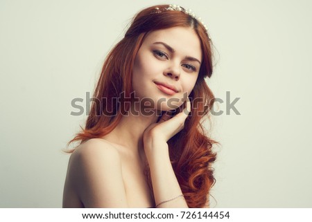 beautiful girl with an accessory on her head smiling on a light background portrait                               
