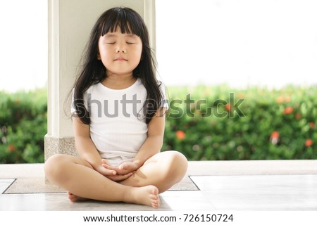 Asian children cute or kid girl sit for meditation with peace and relax in garden pavilion at temple or church and wearing white dress with sunlight on white with space Royalty-Free Stock Photo #726150724