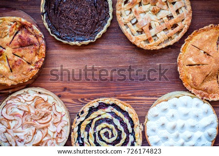 Assorted homemade rustic american style apple, berry, chocolate and lemon meringue pies, top view, copy space