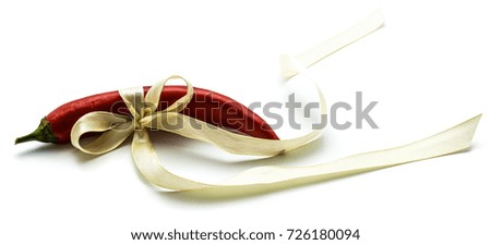 Red Chilli tied with a creamy bow isolated on white background